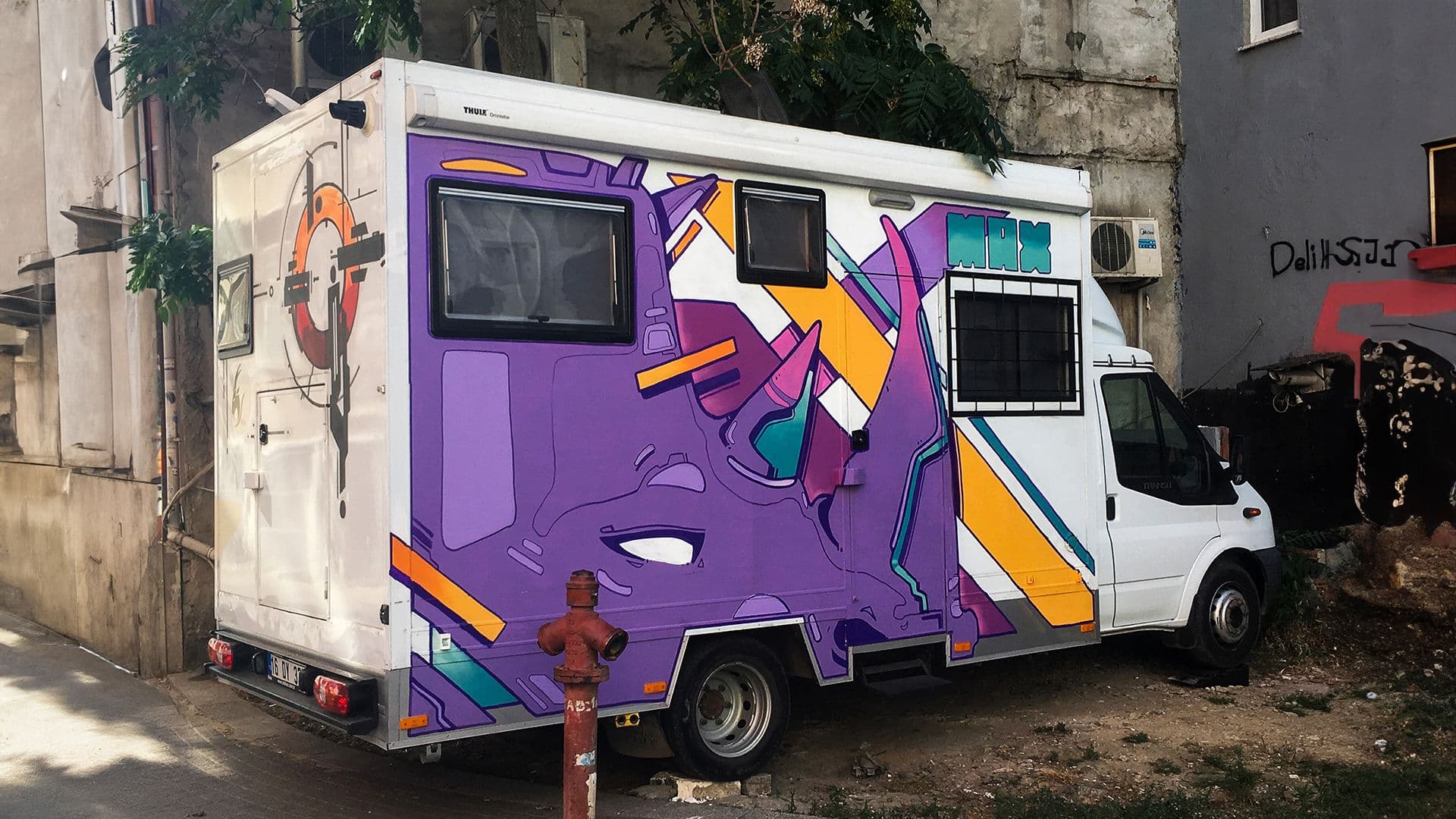 Beyond walls, vehicles such as trucks, cars, and caravans offer exciting surfaces for painting. This was my first vehicle painting. The design was inspired by the power and weight of the rhinoceros, and it was executed to reflect these qualities.